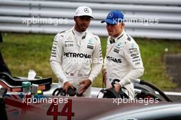 (L to R): Lewis Hamilton (GBR) Mercedes AMG F1 with team mate Valtteri Bottas (FIN) Mercedes AMG F1 in qualifying parc ferme. 07.10.2017. Formula 1 World Championship, Rd 16, Japanese Grand Prix, Suzuka, Japan, Qualifying Day.