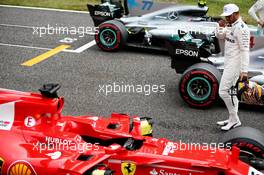 Lewis Hamilton (GBR) Mercedes AMG F1 looks a the Ferrari SF70H of Sebastian Vettel (GER) Ferrari in qualifying parc ferme. 07.10.2017. Formula 1 World Championship, Rd 16, Japanese Grand Prix, Suzuka, Japan, Qualifying Day.