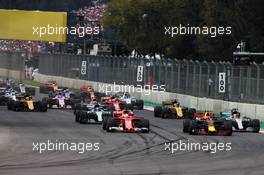 (L to R): Sebastian Vettel (GER) Ferrari SF70H and Max Verstappen (NLD) Red Bull Racing RB13 battle for the lead at the start of the race. 29.10.2017. Formula 1 World Championship, Rd 18, Mexican Grand Prix, Mexico City, Mexico, Race Day.