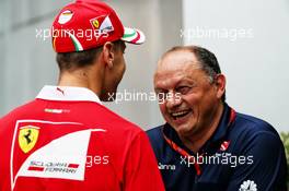 (L to R): Sebastian Vettel (GER) Ferrari with Frederic Vasseur (FRA) Sauber F1 Team, Team Principal. 29.09.2017. Formula 1 World Championship, Rd 15, Malaysian Grand Prix, Sepang, Malaysia, Friday.