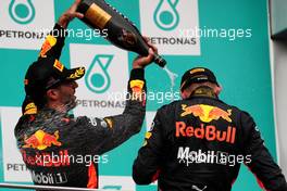 The podium (L to R): Daniel Ricciardo (AUS) Red Bull Racing celebrates his third position with the champagne with race winner and team mate Max Verstappen (NLD) Red Bull Racing. 01.10.2017. Formula 1 World Championship, Rd 15, Malaysian Grand Prix, Sepang, Malaysia, Sunday.