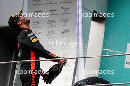 Daniel Ricciardo (AUS) Red Bull Racing celebrates his third with the champagne on the podium. 01.10.2017. Formula 1 World Championship, Rd 15, Malaysian Grand Prix, Sepang, Malaysia, Sunday.