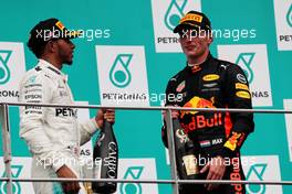 The podium (L to R): Lewis Hamilton (GBR) Mercedes AMG F1 celebrates his second position with the champagne with Max Verstappen (NLD) Red Bull Racing. 01.10.2017. Formula 1 World Championship, Rd 15, Malaysian Grand Prix, Sepang, Malaysia, Sunday.