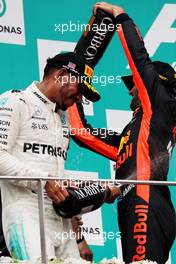 The podium (L to R): Lewis Hamilton (GBR) Mercedes AMG F1 celebrates his second position with the champagne with third placed Daniel Ricciardo (AUS) Red Bull Racing. 01.10.2017. Formula 1 World Championship, Rd 15, Malaysian Grand Prix, Sepang, Malaysia, Sunday.