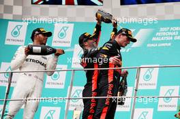 The podium (L to R): Lewis Hamilton (GBR) Mercedes AMG F1 celebrates his second position with the champagne with third placed Daniel Ricciardo (AUS) Red Bull Racing and race winner Max Verstappen (NLD) Red Bull Racing. 01.10.2017. Formula 1 World Championship, Rd 15, Malaysian Grand Prix, Sepang, Malaysia, Sunday.