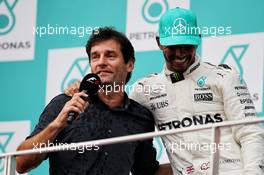 (L to R): Mark Webber (AUS) Channel 4 Presenter on the podium second placed Lewis Hamilton (GBR) Mercedes AMG F1. 01.10.2017. Formula 1 World Championship, Rd 15, Malaysian Grand Prix, Sepang, Malaysia, Sunday.
