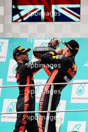 The podium (L to R): Daniel Ricciardo (AUS) Red Bull Racing RB13 celebrates his third position with the champagne with race winner and team mate Max Verstappen (NLD) Red Bull Racing. 01.10.2017. Formula 1 World Championship, Rd 15, Malaysian Grand Prix, Sepang, Malaysia, Sunday.