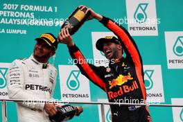 The podium (L to R): Lewis Hamilton (GBR) Mercedes AMG F1 celebrates his second position with the champagne with third placed Daniel Ricciardo (AUS) Red Bull Racing. 01.10.2017. Formula 1 World Championship, Rd 15, Malaysian Grand Prix, Sepang, Malaysia, Sunday.