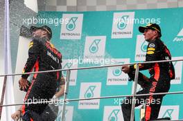 The podium (L to R): Daniel Ricciardo (AUS) Red Bull Racing celebrates his third position with the champagne with team mate and race winner Max Verstappen (NLD) Red Bull Racing. 01.10.2017. Formula 1 World Championship, Rd 15, Malaysian Grand Prix, Sepang, Malaysia, Sunday.