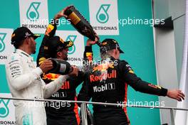 The podium (L to R): Lewis Hamilton (GBR) Mercedes AMG F1 and Daniel Ricciardo (AUS) Red Bull Racing celebrate with the champagne with race winner Max Verstappen (NLD) Red Bull Racing. 01.10.2017. Formula 1 World Championship, Rd 15, Malaysian Grand Prix, Sepang, Malaysia, Sunday.