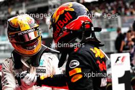 Race winner Max Verstappen (NLD) Red Bull Racing celebrates with second placed Lewis Hamilton (GBR) Mercedes AMG F1 in parc ferme. 01.10.2017. Formula 1 World Championship, Rd 15, Malaysian Grand Prix, Sepang, Malaysia, Sunday.
