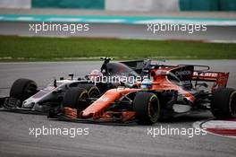 Kevin Magnussen (DEN) Haas VF-17 and Fernando Alonso (ESP) McLaren MCL32 battle for position. 01.10.2017. Formula 1 World Championship, Rd 15, Malaysian Grand Prix, Sepang, Malaysia, Sunday.