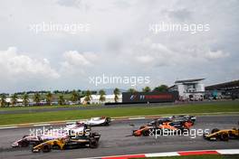 Nico Hulkenberg (GER) Renault Sport F1 Team RS17, Esteban Ocon (FRA) Sahara Force India F1 VJM10, and Felipe Massa (BRA) Williams FW40, at the start of the race.                                01.10.2017. Formula 1 World Championship, Rd 15, Malaysian Grand Prix, Sepang, Malaysia, Sunday.