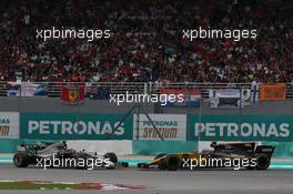 Kevin Magnussen (DEN) Haas VF-17 and Jolyon Palmer (GBR) Renault Sport F1 Team RS17. 01.10.2017. Formula 1 World Championship, Rd 15, Malaysian Grand Prix, Sepang, Malaysia, Sunday.