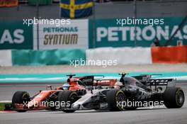 Fernando Alonso (ESP) McLaren MCL32 and Kevin Magnussen (DEN) Haas VF-17 battle for position. 01.10.2017. Formula 1 World Championship, Rd 15, Malaysian Grand Prix, Sepang, Malaysia, Sunday.
