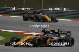 Nico Hulkenberg (GER) Renault Sport F1 Team RS17 and Jolyon Palmer (GBR) Renault Sport F1 Team RS17. 01.10.2017. Formula 1 World Championship, Rd 15, Malaysian Grand Prix, Sepang, Malaysia, Sunday.