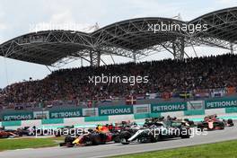Valtteri Bottas (FIN) Mercedes AMG F1 W08 and Max Verstappen (NLD) Red Bull Racing RB13 at the start of the race. 01.10.2017. Formula 1 World Championship, Rd 15, Malaysian Grand Prix, Sepang, Malaysia, Sunday.