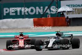 Valtteri Bottas (FIN) Mercedes AMG F1 W08 leads Sebastian Vettel (GER) Ferrari SF70H. 01.10.2017. Formula 1 World Championship, Rd 15, Malaysian Grand Prix, Sepang, Malaysia, Sunday.