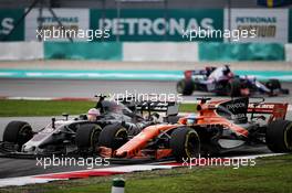 Kevin Magnussen (DEN) Haas VF-17 and Fernando Alonso (ESP) McLaren MCL32 battle for position. 01.10.2017. Formula 1 World Championship, Rd 15, Malaysian Grand Prix, Sepang, Malaysia, Sunday.