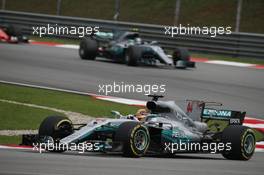 Lewis Hamilton (GBR) Mercedes AMG F1 W08 and Valtteri Bottas (FIN) Mercedes AMG F1 W08. 01.10.2017. Formula 1 World Championship, Rd 15, Malaysian Grand Prix, Sepang, Malaysia, Sunday.