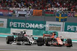 Kevin Magnussen (DEN) Haas VF-17 and Fernando Alonso (ESP) McLaren MCL32. 01.10.2017. Formula 1 World Championship, Rd 15, Malaysian Grand Prix, Sepang, Malaysia, Sunday.