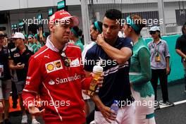 (L to R): Sebastian Vettel (GER) Ferrari with Pascal Wehrlein (GER) Sauber F1 Team on the drivers parade.                                01.10.2017. Formula 1 World Championship, Rd 15, Malaysian Grand Prix, Sepang, Malaysia, Sunday.