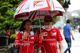 Kimi Raikkonen (FIN) Ferrari with Stefania Bocchi (ITA) Ferrari Press Officer. 28.09.2017. Formula 1 World Championship, Rd 15, Malaysian Grand Prix, Sepang, Malaysia, Thursday.