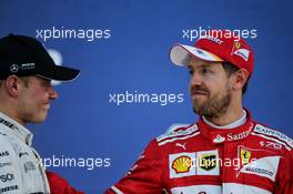 (L to R): Race winner Valtteri Bottas (FIN) Mercedes AMG F1 celebrates on the podium with second placed Sebastian Vettel (GER) Ferrari. 30.04.2017. Formula 1 World Championship, Rd 4, Russian Grand Prix, Sochi Autodrom, Sochi, Russia, Race Day.