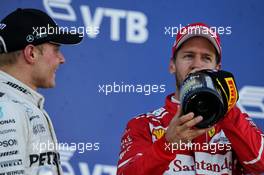 (L to R): Race winner Valtteri Bottas (FIN) Mercedes AMG F1 celebrates on the podium with second placed Sebastian Vettel (GER) Ferrari. 30.04.2017. Formula 1 World Championship, Rd 4, Russian Grand Prix, Sochi Autodrom, Sochi, Russia, Race Day.