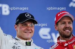 (L to R): Race winner Valtteri Bottas (FIN) Mercedes AMG F1 celebrates on the podium with second placed Sebastian Vettel (GER) Ferrari. 30.04.2017. Formula 1 World Championship, Rd 4, Russian Grand Prix, Sochi Autodrom, Sochi, Russia, Race Day.