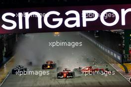 Sebastian Vettel (GER) Ferrari SF70H, Kimi Raikkonen (FIN) Ferrari SF70H, and Max Verstappen (NLD) Red Bull Racing RB13, crash at the start of the race. 17.09.2017. Formula 1 World Championship, Rd 14, Singapore Grand Prix, Marina Bay Street Circuit, Singapore, Race Day.