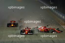 Sebastian Vettel (GER) Ferrari SF70H, Kimi Raikkonen (FIN) Ferrari SF70H, and Max Verstappen (NLD) Red Bull Racing RB13, crash at the start of the race 17.09.2017. Formula 1 World Championship, Rd 14, Singapore Grand Prix, Marina Bay Street Circuit, Singapore, Race Day.