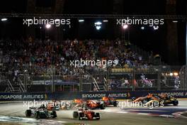 Sebastian Vettel (GER) Ferrari SF70H and Lewis Hamilton (GBR) Mercedes AMG F1 W08 leads at the start of the race as Kimi Raikkonen (FIN) Ferrari SF70H, Max Verstappen (NLD) Red Bull Racing RB13 and Fernando Alonso (ESP) McLaren MCL32, crash.                                17.09.2017. Formula 1 World Championship, Rd 14, Singapore Grand Prix, Marina Bay Street Circuit, Singapore, Race Day.