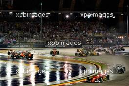 Sebastian Vettel (GER) Ferrari SF70H and Lewis Hamilton (GBR) Mercedes AMG F1 W08 leads at the start of the race as Kimi Raikkonen (FIN) Ferrari SF70H, Max Verstappen (NLD) Red Bull Racing RB13 and Fernando Alonso (ESP) McLaren MCL32, crash.                                17.09.2017. Formula 1 World Championship, Rd 14, Singapore Grand Prix, Marina Bay Street Circuit, Singapore, Race Day.