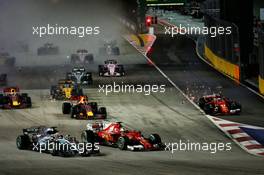 Sebastian Vettel (GER) Ferrari SF70H, Kimi Raikkonen (FIN) Ferrari SF70H, and Max Verstappen (NLD) Red Bull Racing RB13, crash at the start of the race. 17.09.2017. Formula 1 World Championship, Rd 14, Singapore Grand Prix, Marina Bay Street Circuit, Singapore, Race Day.