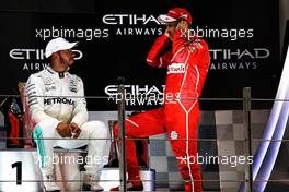 (L to R): Second placed Lewis Hamilton (GBR) Mercedes AMG F1 on the podium with third placed Sebastian Vettel (GER) Ferrari. 26.11.2017. Formula 1 World Championship, Rd 20, Abu Dhabi Grand Prix, Yas Marina Circuit, Abu Dhabi, Race Day.