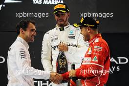 (L to R): Lewis Hamilton (GBR) Mercedes AMG F1 celebrates his second position on the podium with third placed Sebastian Vettel (GER) Ferrari. 26.11.2017. Formula 1 World Championship, Rd 20, Abu Dhabi Grand Prix, Yas Marina Circuit, Abu Dhabi, Race Day.