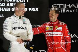 The podium (L to R): Race winner Valtteri Bottas (FIN) Mercedes AMG F1 celebrates with third placed Sebastian Vettel (GER) Ferrari. 26.11.2017. Formula 1 World Championship, Rd 20, Abu Dhabi Grand Prix, Yas Marina Circuit, Abu Dhabi, Race Day.