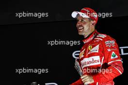 Sebastian Vettel (GER) Ferrari celebrates his third position on the podium. 26.11.2017. Formula 1 World Championship, Rd 20, Abu Dhabi Grand Prix, Yas Marina Circuit, Abu Dhabi, Race Day.