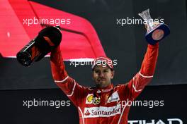 Sebastian Vettel (GER) Ferrari celebrates his third position on the podium. 26.11.2017. Formula 1 World Championship, Rd 20, Abu Dhabi Grand Prix, Yas Marina Circuit, Abu Dhabi, Race Day.