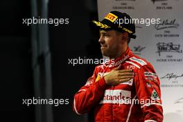 Sebastian Vettel (GER) Ferrari celebrates his third position on the podium. 26.11.2017. Formula 1 World Championship, Rd 20, Abu Dhabi Grand Prix, Yas Marina Circuit, Abu Dhabi, Race Day.