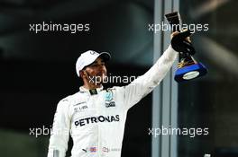 Lewis Hamilton (GBR) Mercedes AMG F1 celebrates his third position on the podium. 26.11.2017. Formula 1 World Championship, Rd 20, Abu Dhabi Grand Prix, Yas Marina Circuit, Abu Dhabi, Race Day.
