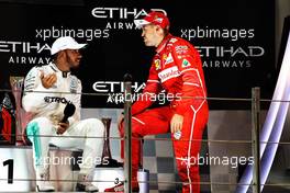 (L to R): Second placed Lewis Hamilton (GBR) Mercedes AMG F1 on the podium with third placed Sebastian Vettel (GER) Ferrari. 26.11.2017. Formula 1 World Championship, Rd 20, Abu Dhabi Grand Prix, Yas Marina Circuit, Abu Dhabi, Race Day.