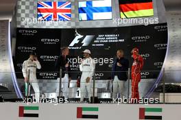 The podium (L to R): Race winner Lewis Hamilton (GBR) Mercedes AMG F1 with David Coulthard (GBR) Red Bull Racing and Scuderia Toro Advisor / Channel 4 F1 Commentator; Lewis Hamilton (GBR) Mercedes AMG F1; Martin Brundle (GBR) Sky Sports Commentator; and Sebastian Vettel (GER) Ferrari. 26.11.2017. Formula 1 World Championship, Rd 20, Abu Dhabi Grand Prix, Yas Marina Circuit, Abu Dhabi, Race Day.