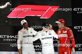 The podium - with new F1 logo - (L to R): Lewis Hamilton (GBR) Mercedes AMG F1, second; Valtteri Bottas (FIN) Mercedes AMG F1, race winner; Sebastian Vettel (GER) Ferrari, third. 26.11.2017. Formula 1 World Championship, Rd 20, Abu Dhabi Grand Prix, Yas Marina Circuit, Abu Dhabi, Race Day.