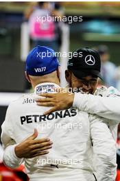 Valtteri Bottas (FIN) Mercedes AMG F1 celebrates his pole position with second placed team mate Lewis Hamilton (GBR) Mercedes AMG F1 in qualifying parc ferme. 25.11.2017. Formula 1 World Championship, Rd 20, Abu Dhabi Grand Prix, Yas Marina Circuit, Abu Dhabi, Qualifying Day.