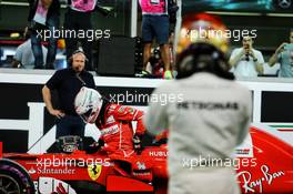 Sebastian Vettel (GER) Ferrari SF70H and Lewis Hamilton (GBR) Mercedes AMG F1 in qualifying parc ferme. 25.11.2017. Formula 1 World Championship, Rd 20, Abu Dhabi Grand Prix, Yas Marina Circuit, Abu Dhabi, Qualifying Day.