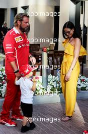 Minttu Raikkonen (FIN), wife of Kimi Raikkonen (FIN) Ferrari son Robin and Gino Rosato (CDN) Ferrari. 25.11.2017. Formula 1 World Championship, Rd 20, Abu Dhabi Grand Prix, Yas Marina Circuit, Abu Dhabi, Qualifying Day.