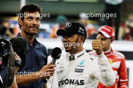 (L to R): Mark Webber (AUS) Channel 4 Presenter with Lewis Hamilton (GBR) Mercedes AMG F1 in qualifying parc ferme. 25.11.2017. Formula 1 World Championship, Rd 20, Abu Dhabi Grand Prix, Yas Marina Circuit, Abu Dhabi, Qualifying Day.