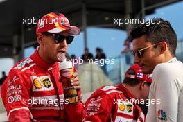 (L to R): Sebastian Vettel (GER) Ferrari with Pascal Wehrlein (GER) Sauber F1 Team on the drivers parade. 26.11.2017. Formula 1 World Championship, Rd 20, Abu Dhabi Grand Prix, Yas Marina Circuit, Abu Dhabi, Race Day.